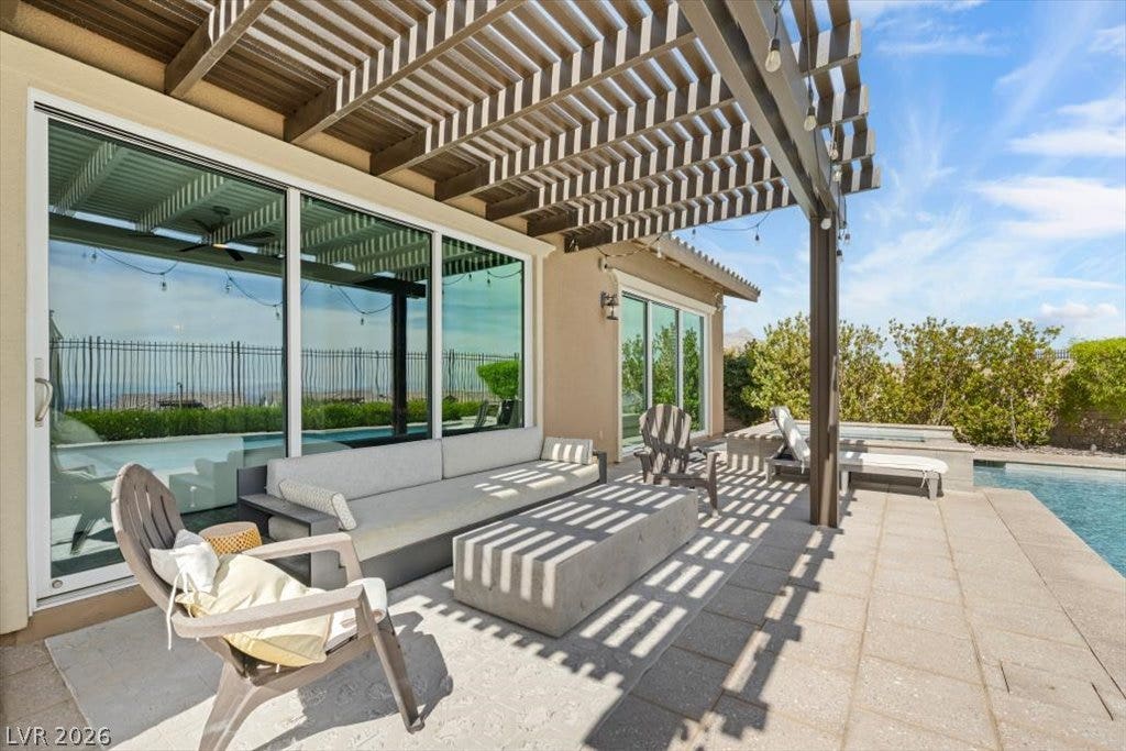 286 Besame Court, Las Vegas, NV 89138 A spacious paved patio features a substantial wood pergola and direct pool access.