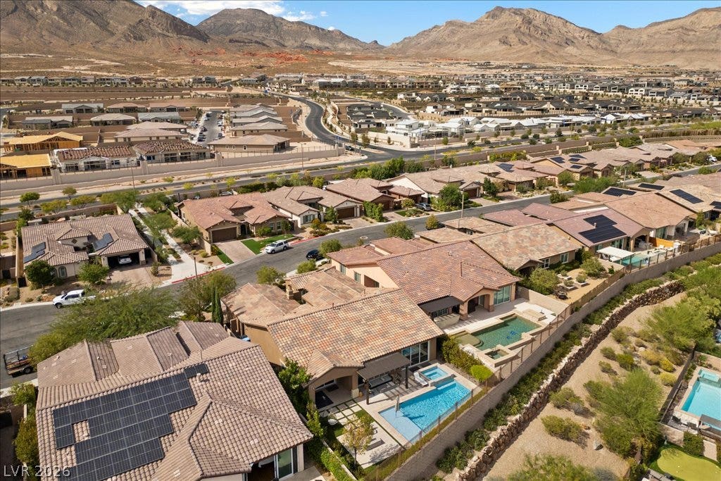 286 Besame Court, Las Vegas, NV 89138 Majestic mountain ridges frame a peaceful desert neighborhood of tile-roofed residences.