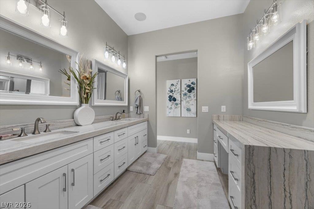 286 Besame Court, Las Vegas, NV 89138 Plentiful counter space, dual sinks, and wood-look flooring define this main bath area.