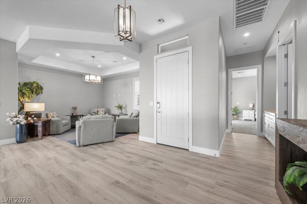 286 Besame Court, Las Vegas, NV 89138 Gleaming wood-look floors anchor a welcoming entryway transitioning seamlessly into the main living spaces.