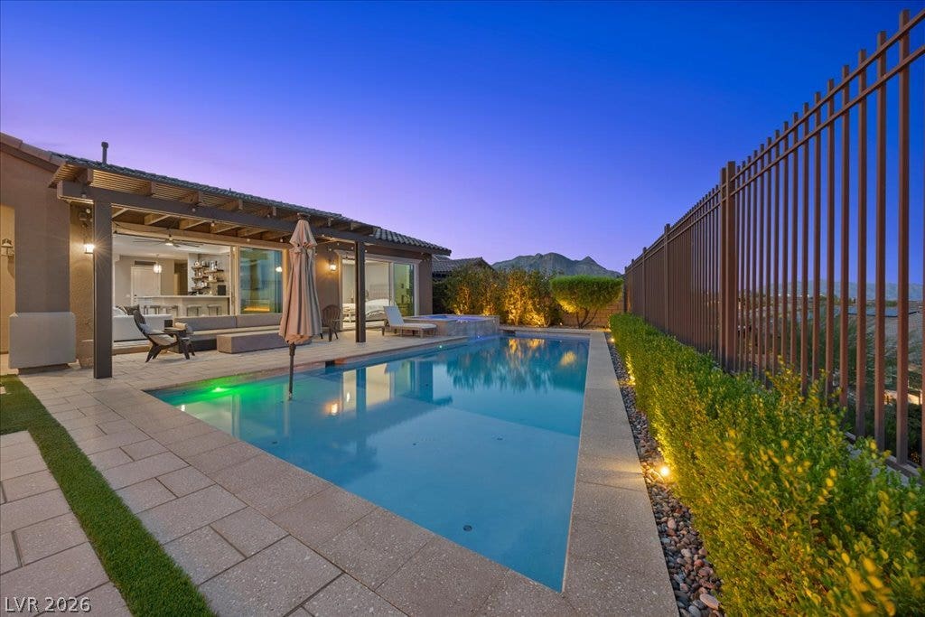 286 Besame Court, Las Vegas, NV 89138 An inviting swimming pool and paved patio set against a scenic desert mountain backdrop.