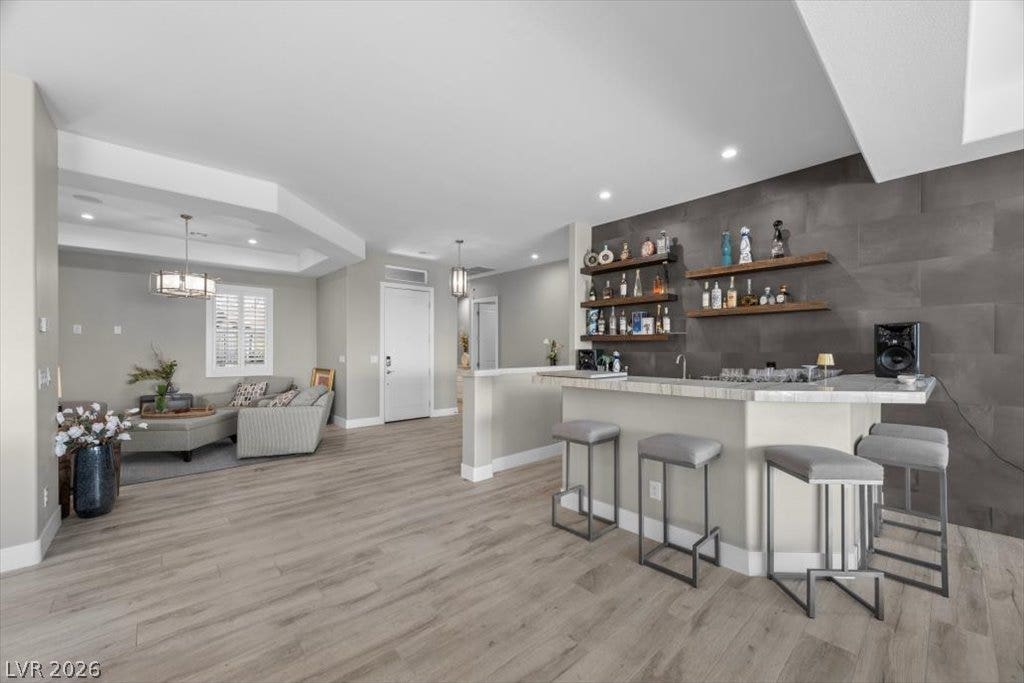 286 Besame Court, Las Vegas, NV 89138 Gleaming wood-look floors anchor a sleek wet bar perfect for effortless entertaining.