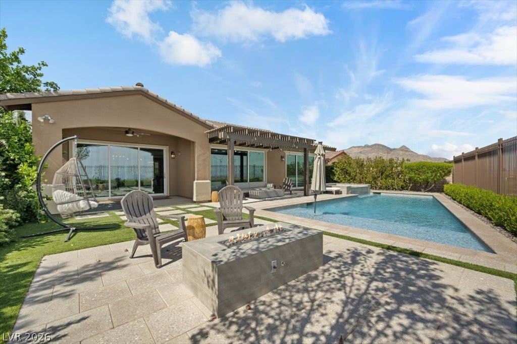 286 Besame Court, Las Vegas, NV 89138 A sparkling in-ground pool and modern fire pit highlight this desert oasis backyard.