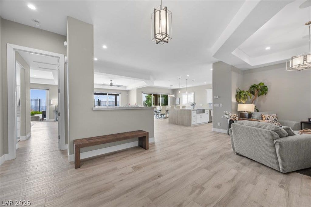 286 Besame Court, Las Vegas, NV 89138 An open layout flows effortlessly across light wood flooring under architectural ceilings.