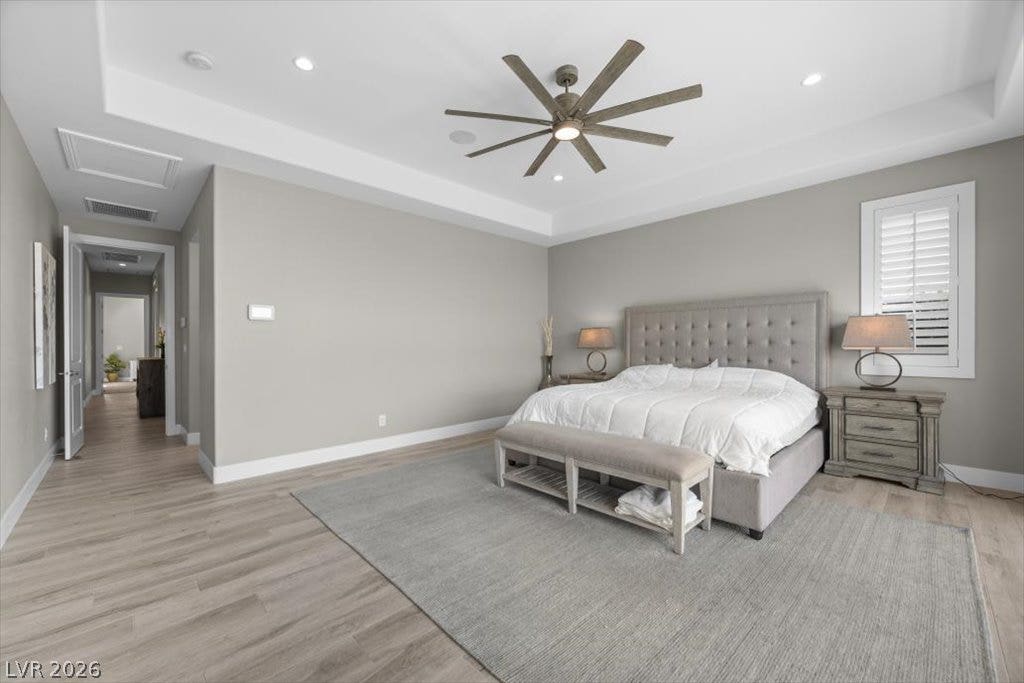 286 Besame Court, Las Vegas, NV 89138 Elegant tray ceilings and luxury wood-look flooring define this serene main suite retreat.
