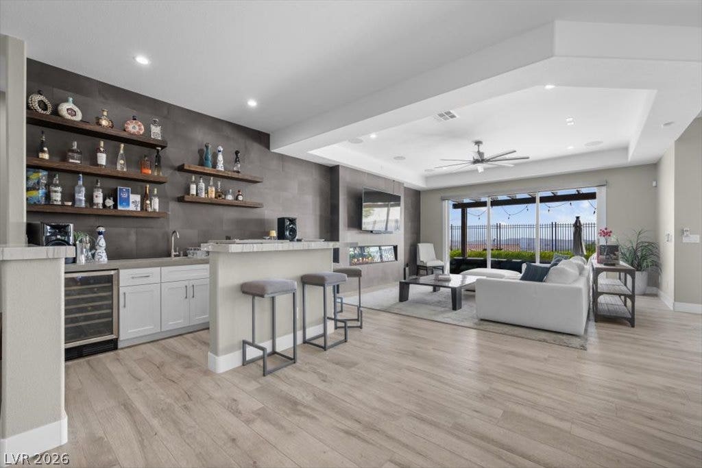 286 Besame Court, Las Vegas, NV 89138 Gleaming wood floors anchor this open living area featuring a modern wet bar.