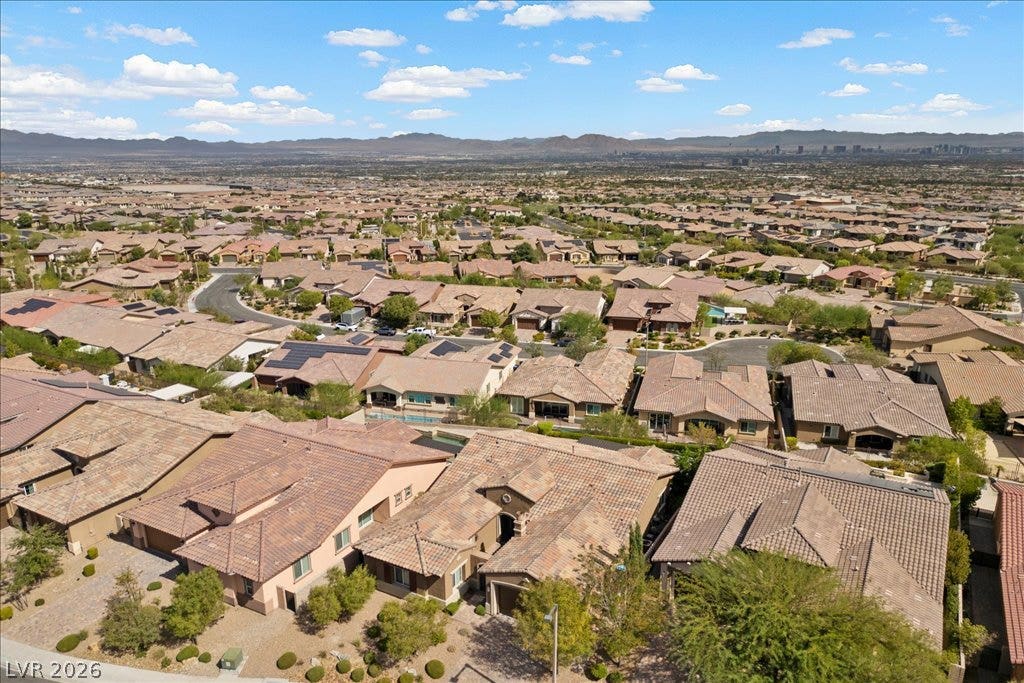 286 Besame Court, Las Vegas, NV 89138 Distant mountains frame a vast neighborhood view of tiled roofs and winding streets.