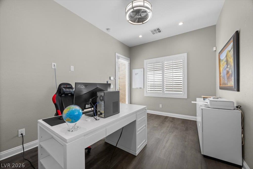 286 Besame Court, Las Vegas, NV 89138 Rich wood-look flooring and crisp plantation shutters define this versatile home workspace.
