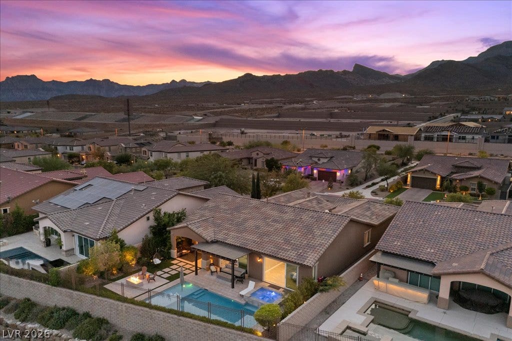 286 Besame Court, Las Vegas, NV 89138 Dramatic mountain vistas frame this desert landscape during a vibrant sunset sky.