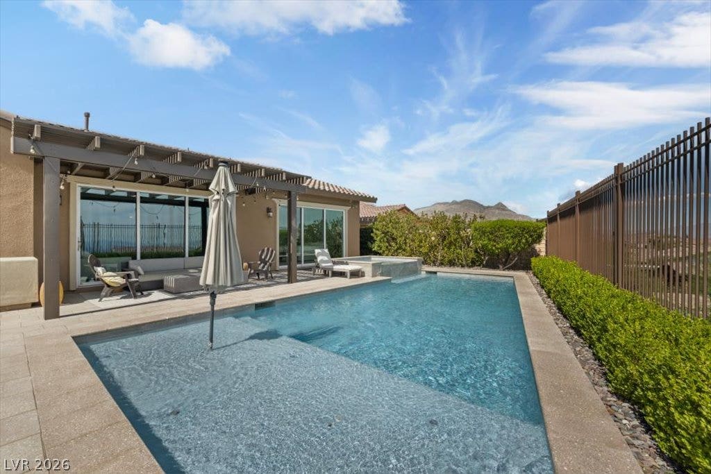 286 Besame Court, Las Vegas, NV 89138 An inviting backyard oasis showcases a sparkling swimming pool paired with a shaded patio space.
