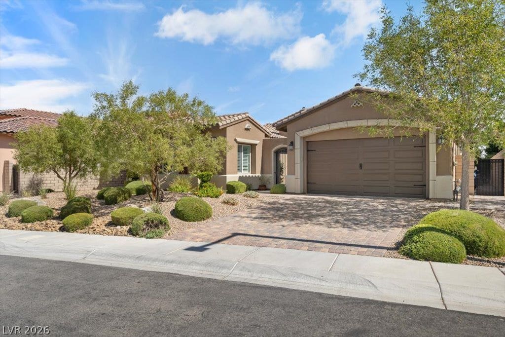 286 Besame Court, Las Vegas, NV 89138 Desert landscaping and a paved driveway complement this elegant tile-roof home.