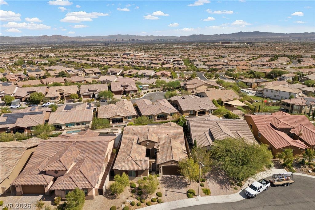 286 Besame Court, Las Vegas, NV 89138 Distant mountains frame a sweeping aerial perspective of this quiet desert neighborhood.