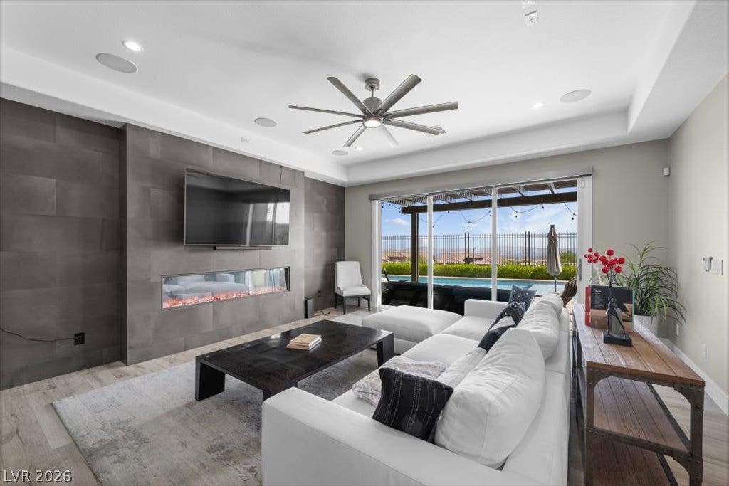 286 Besame Court, Las Vegas, NV 89138 A modern fireplace accent wall anchors this comfortable living room with sliding glass door access.