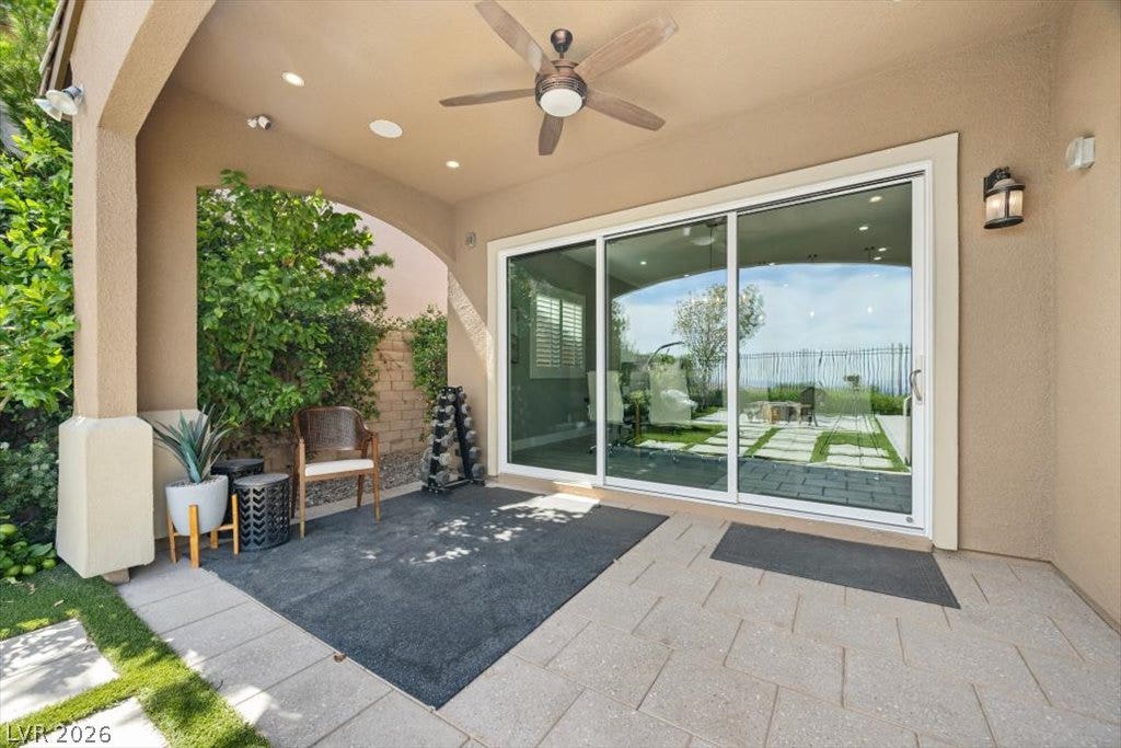 286 Besame Court, Las Vegas, NV 89138 Shaded stone tiling leads directly to wide glass doors opening into the home.
