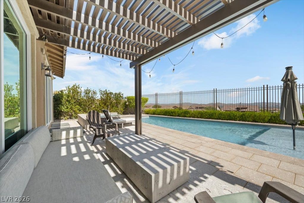 286 Besame Court, Las Vegas, NV 89138 An inviting backyard oasis features a shimmering lap pool alongside a shaded patio structure.