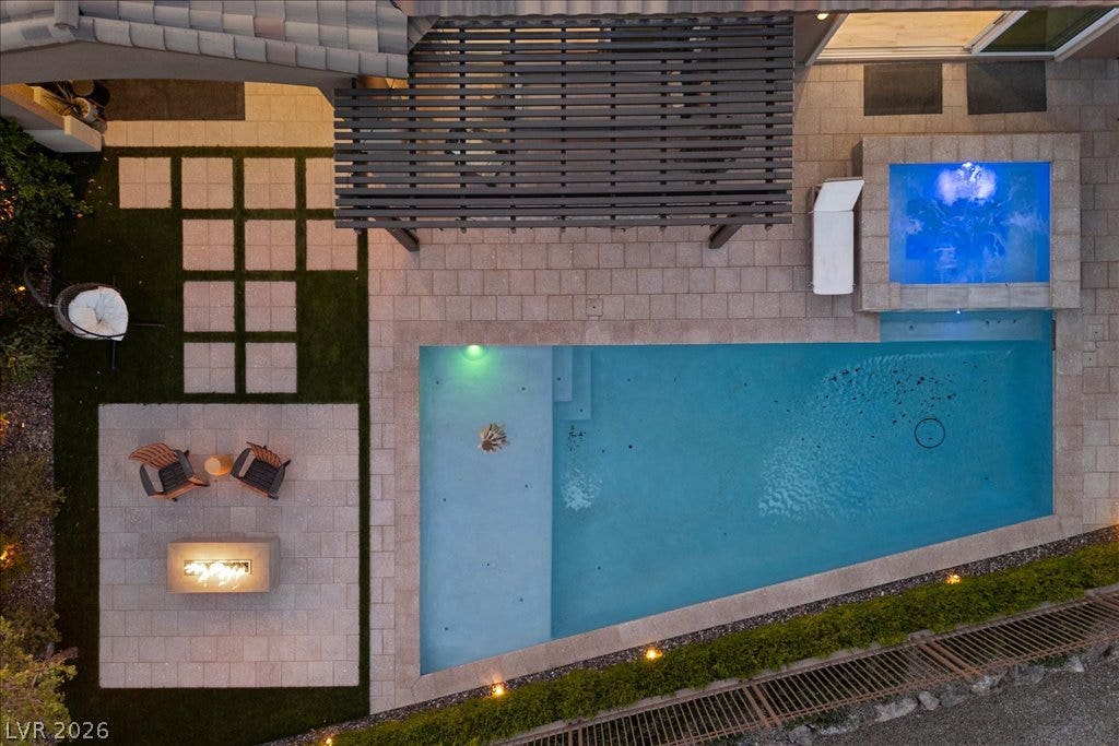 286 Besame Court, Las Vegas, NV 89138 An overhead view reveals a geometric swimming pool, integrated spa, pergola, and stone pavers.