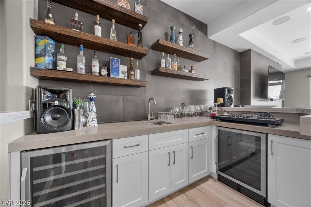 286 Besame Court, Las Vegas, NV 89138 Rich open shelving and modern stone counters anchor this stylish wet bar area.