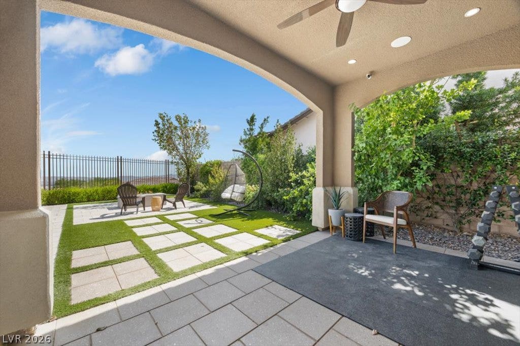 286 Besame Court, Las Vegas, NV 89138 A sheltered tiled patio leads to a landscaped lawn framing neighborhood views.