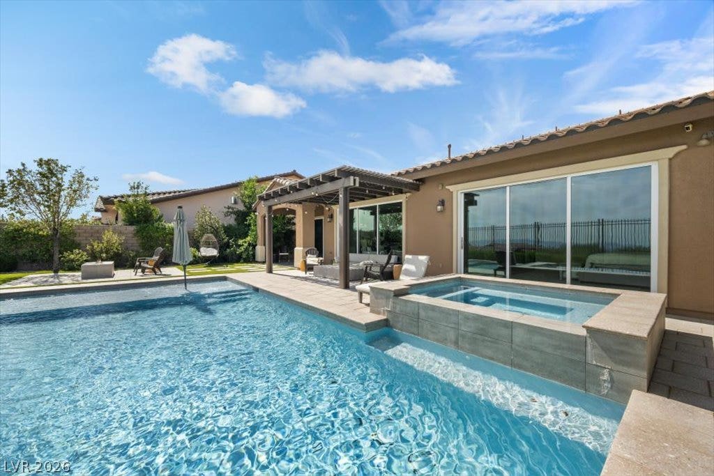 286 Besame Court, Las Vegas, NV 89138 An inviting backyard oasis features a shimmering swimming pool alongside a raised spa.