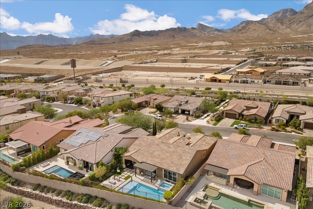 286 Besame Court, Las Vegas, NV 89138 Dramatic mountain backdrops frame a quiet neighborhood of contemporary homes with private backyard swimming pools.