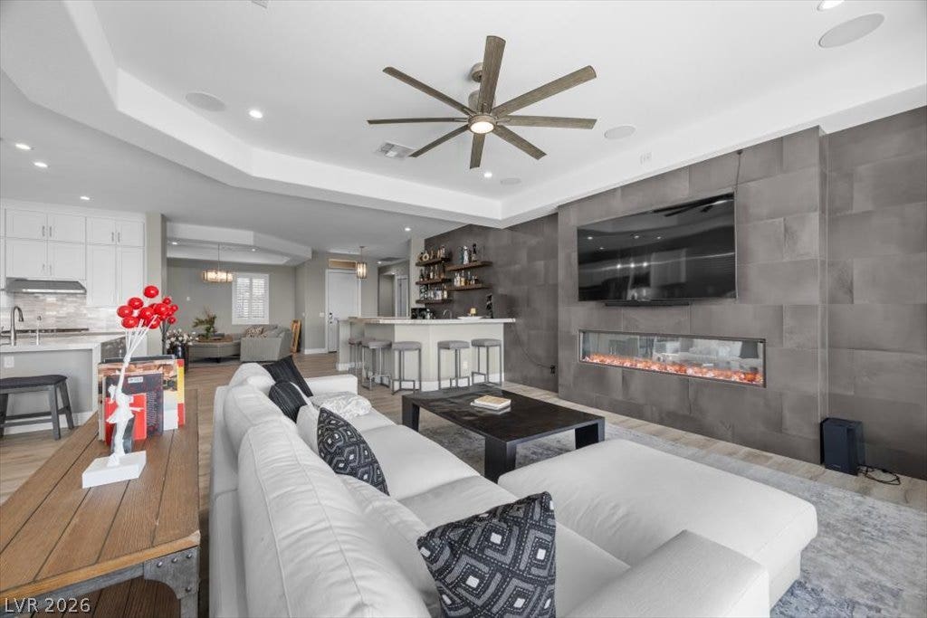 286 Besame Court, Las Vegas, NV 89138 A modern fireplace is set into a tiled accent wall in this open floorplan.