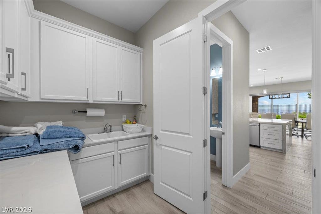 286 Besame Court, Las Vegas, NV 89138 Ample built-in cabinetry and a deep utility sink elevate this functional service area.