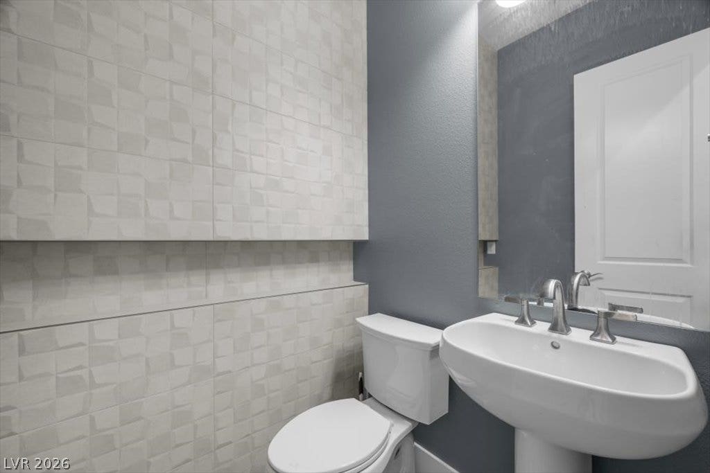 286 Besame Court, Las Vegas, NV 89138 A stylish pedestal sink and geometric wall tile define this modern powder room.