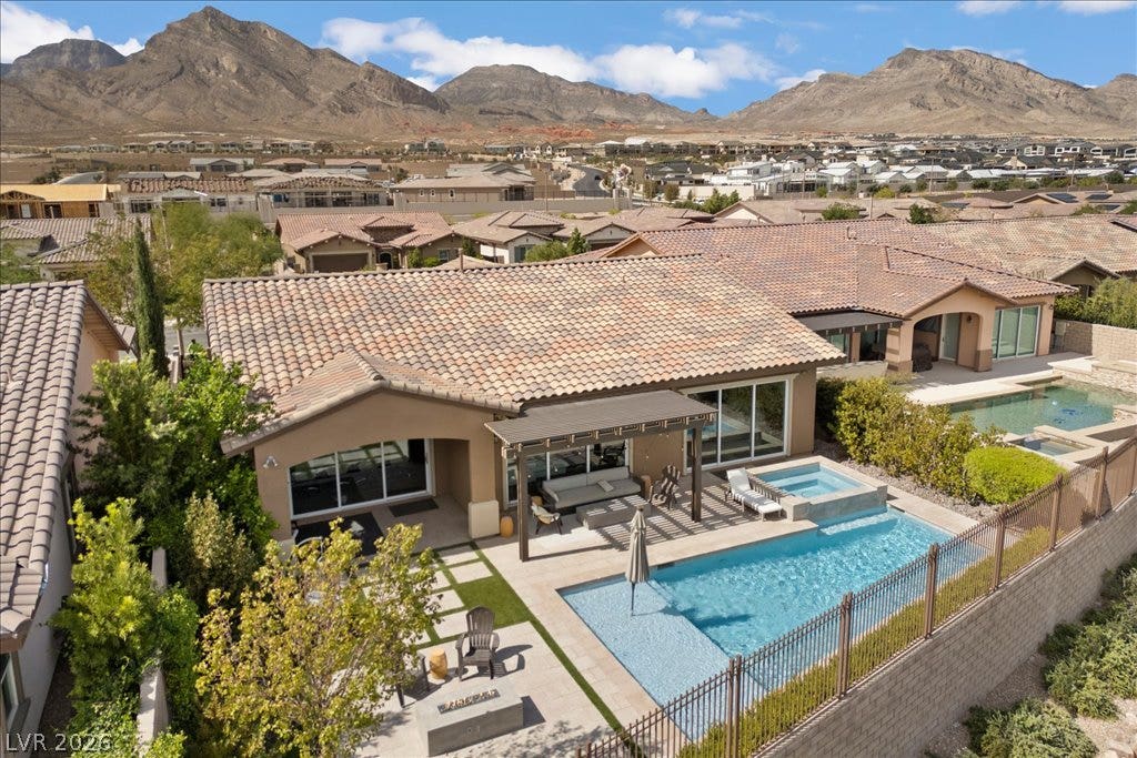 286 Besame Court, Las Vegas, NV 89138 Dramatic mountain peaks frame this backyard retreat featuring a sparkling swimming pool.