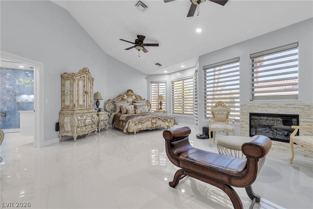3341 Camino Gardens Way, Las Vegas, NV 89146 Gleaming tile floors and vaulted ceilings define this grand bedroom suite featuring a stone fireplace.