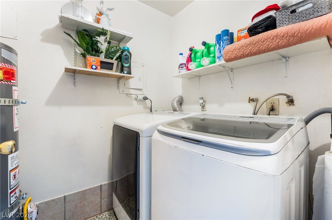 2515 Donna Street, #C, North Las Vegas, NV 89030 Functional laundry space features overhead shelving, patterned floor tile, and practical appliance hookups.
