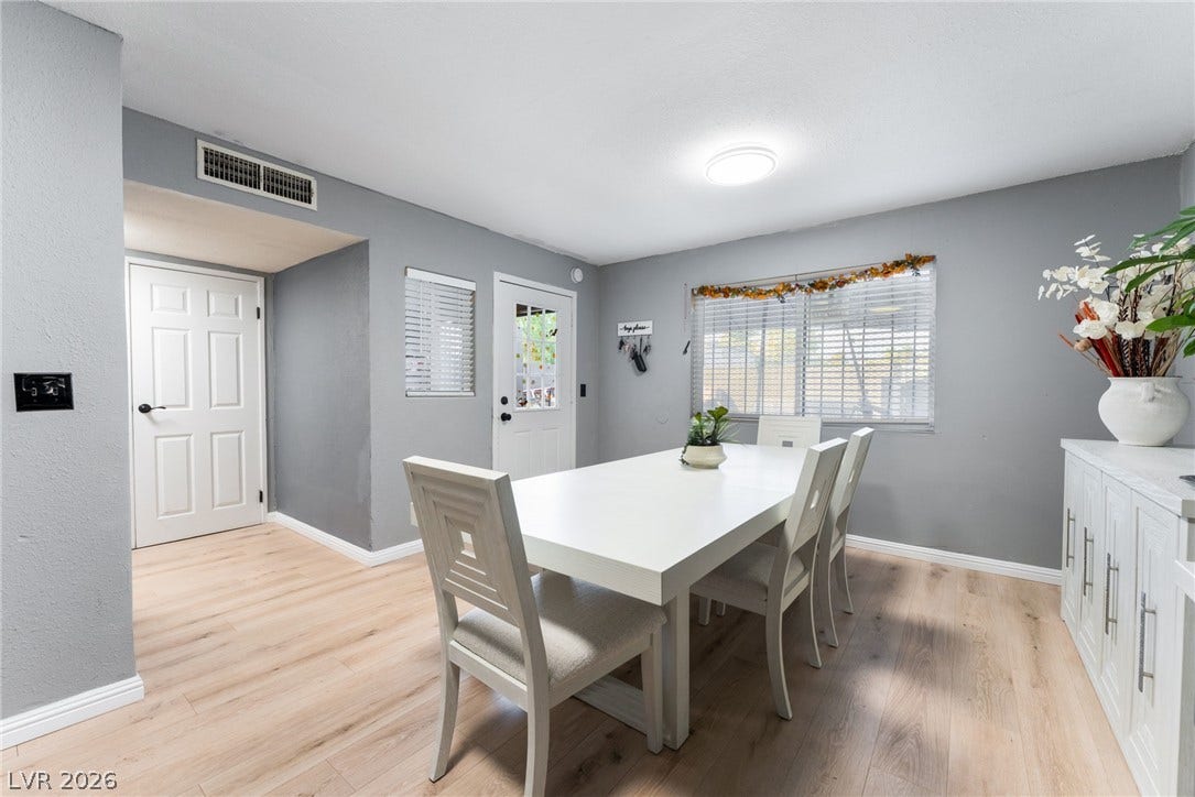 2515 Donna Street, #C, North Las Vegas, NV 89030 Warm wood-look flooring and integrated cabinetry anchor this inviting dining area.
