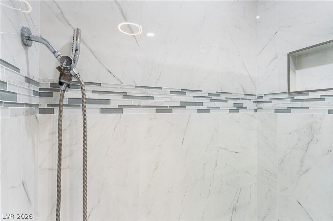 2515 Donna Street, #C, North Las Vegas, NV 89030 Elegantly tiled walls pair with a handheld shower fixture in this modern design.
