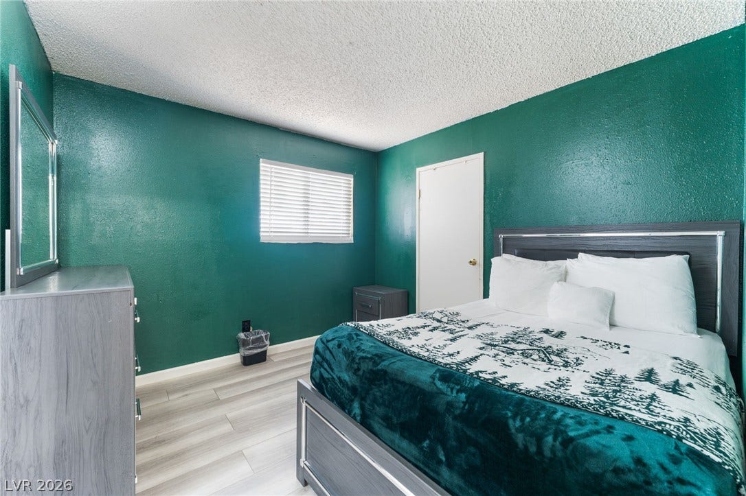 2515 Donna Street, #C, North Las Vegas, NV 89030 Smooth laminate flooring and a textured ceiling frame this bedroom.
