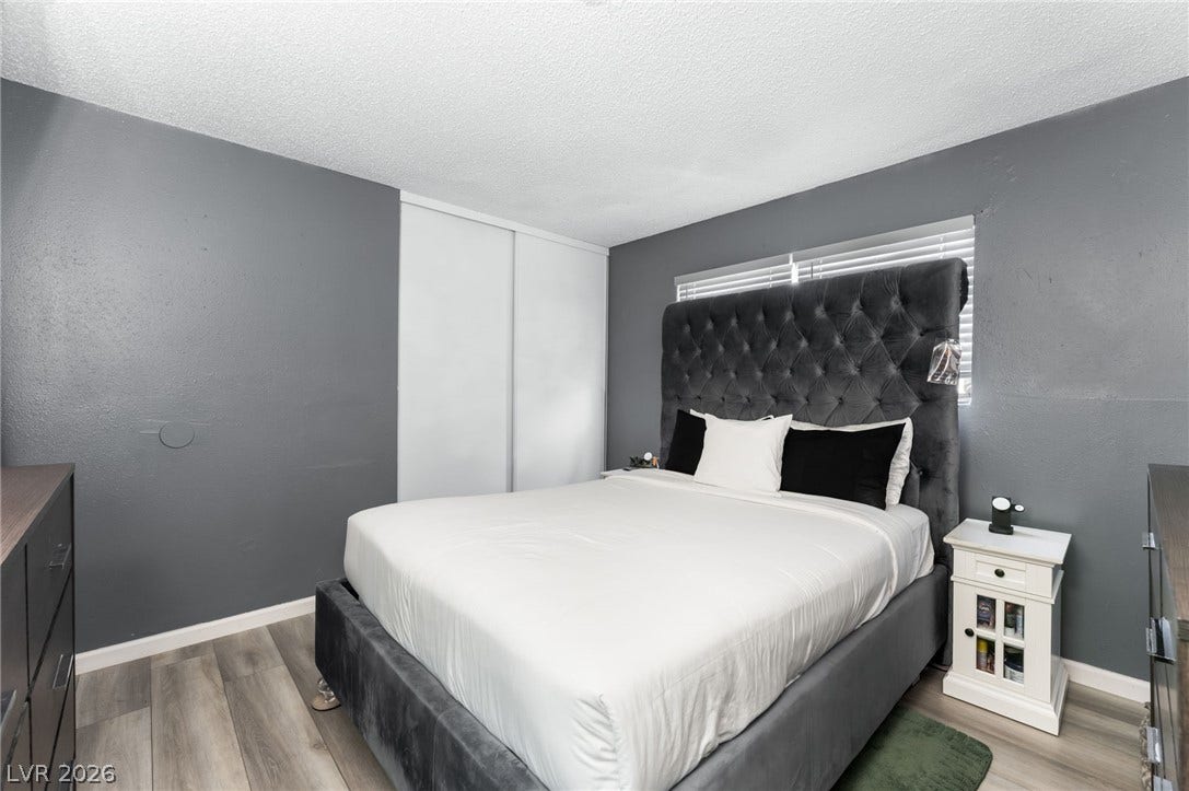 2515 Donna Street, #C, North Las Vegas, NV 89030 A window overlooks the space featuring sleek modern flooring and closet doors.