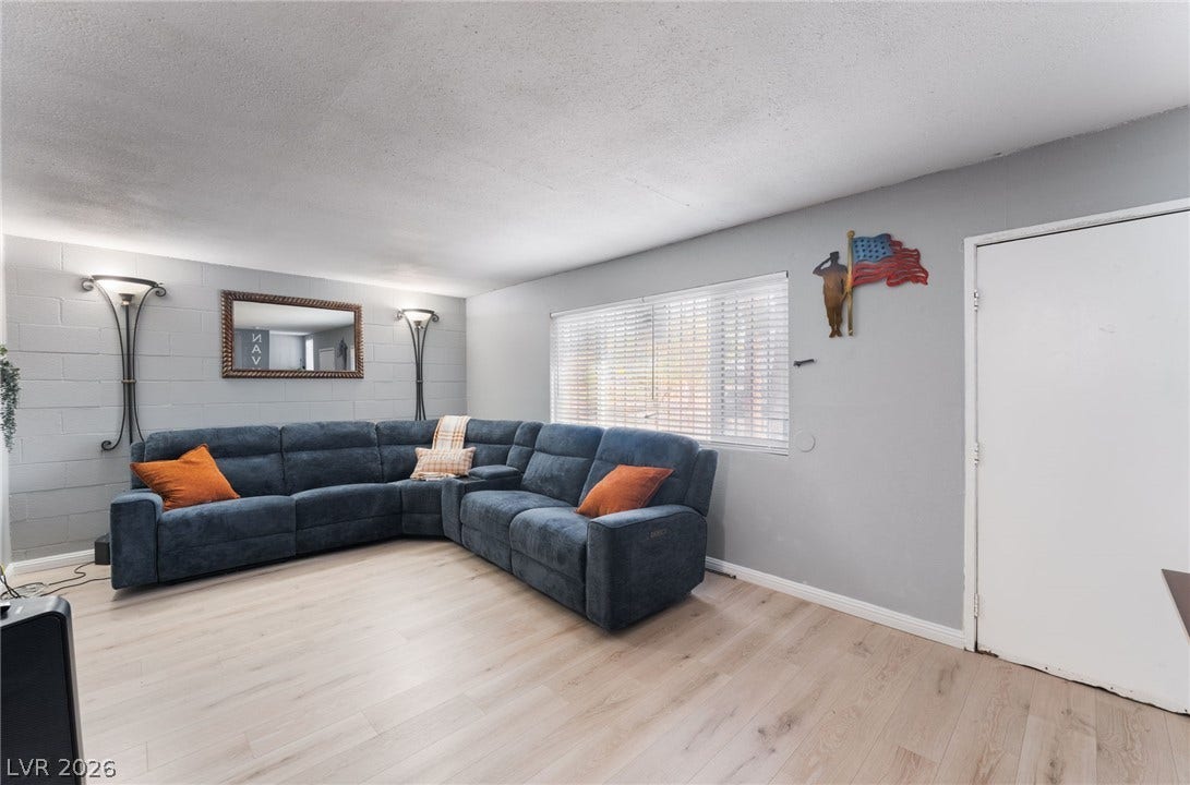 2515 Donna Street, #C, North Las Vegas, NV 89030 Smooth wood-style flooring runs through this comfortable living space lit by a wide window.