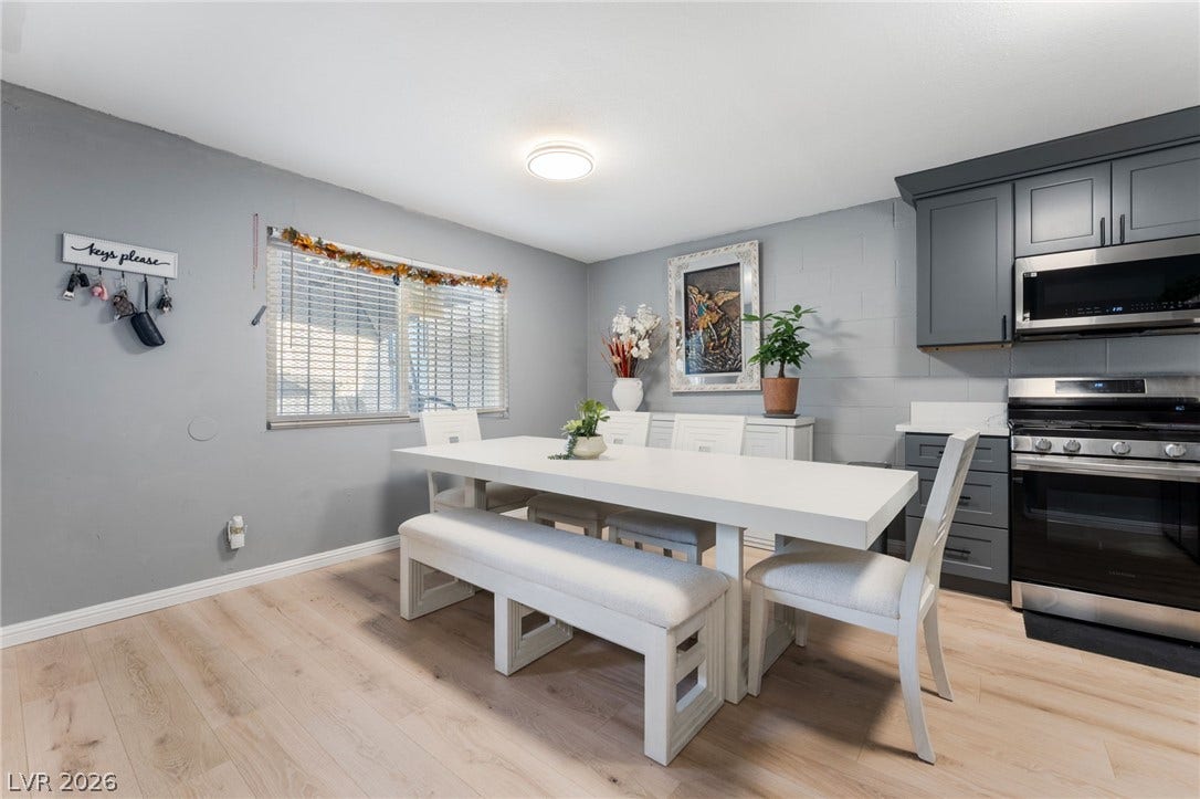 2515 Donna Street, #C, North Las Vegas, NV 89030 An inviting dining area flows seamlessly into the kitchen with modern wood-style flooring.