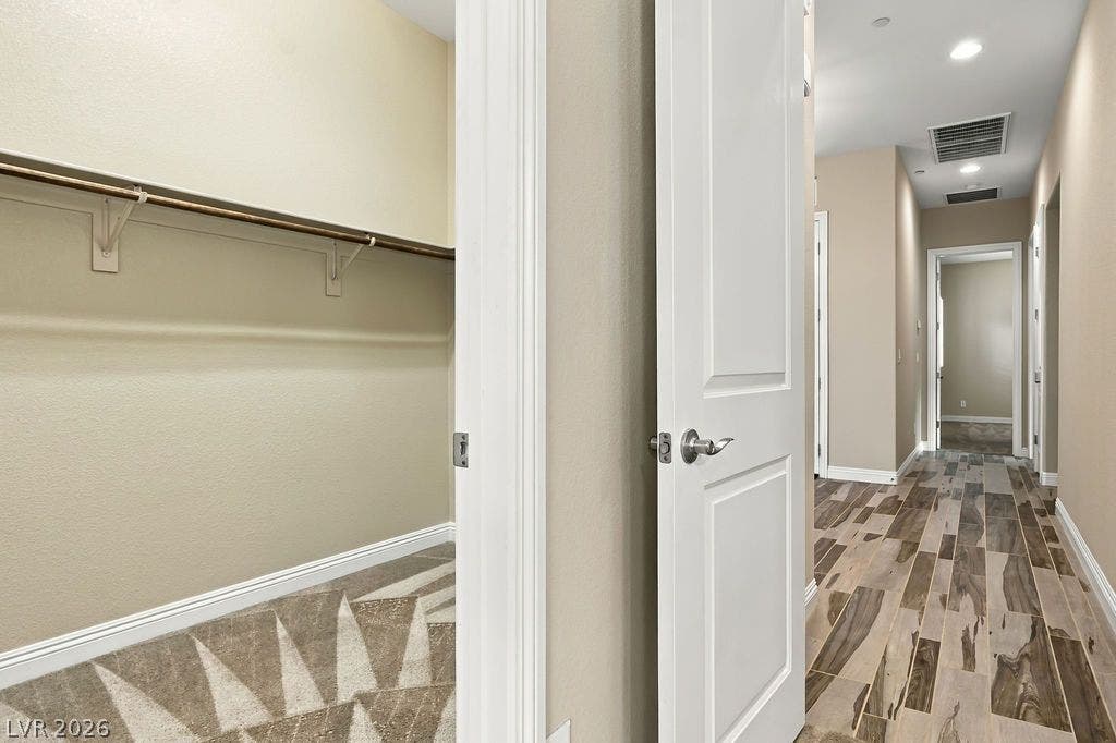 286 Lindura Court, Las Vegas, NV 89138 An inviting hallway featuring wood-look tile floors leads past a spacious closet organizer.