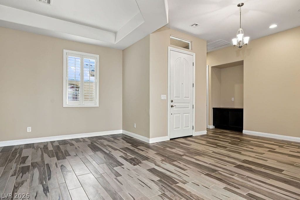 286 Lindura Court, Las Vegas, NV 89138 Elegant wood-look ceramic tile flooring flows through the entry, accented by architectural ceiling details.