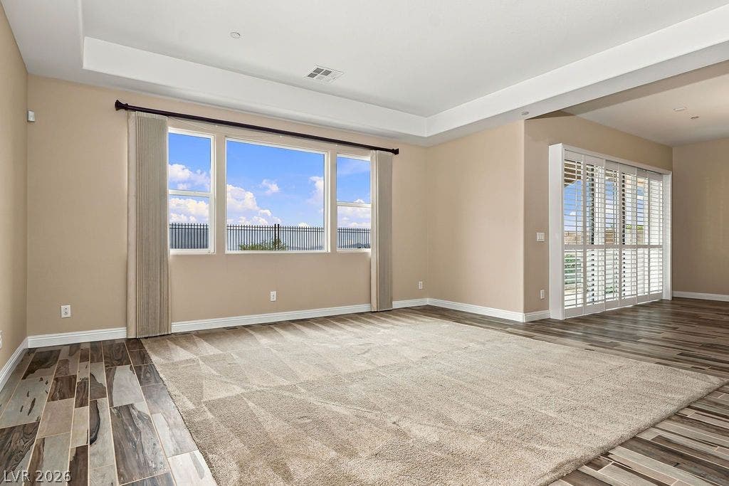 286 Lindura Court, Las Vegas, NV 89138 Recessed ceiling details and wood-look flooring define this open living space.