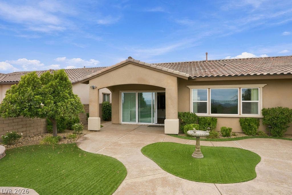286 Lindura Court, Las Vegas, NV 89138 A covered patio and concrete walkways define the rear of this stucco residence.