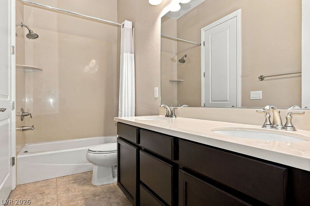 286 Lindura Court, Las Vegas, NV 89138 A spacious double vanity and tile flooring highlight this classic guest bathroom.