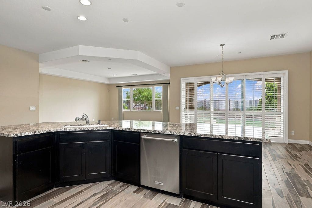 286 Lindura Court, Las Vegas, NV 89138 Polished stone countertops complement dark cabinetry in this airy open-concept layout.