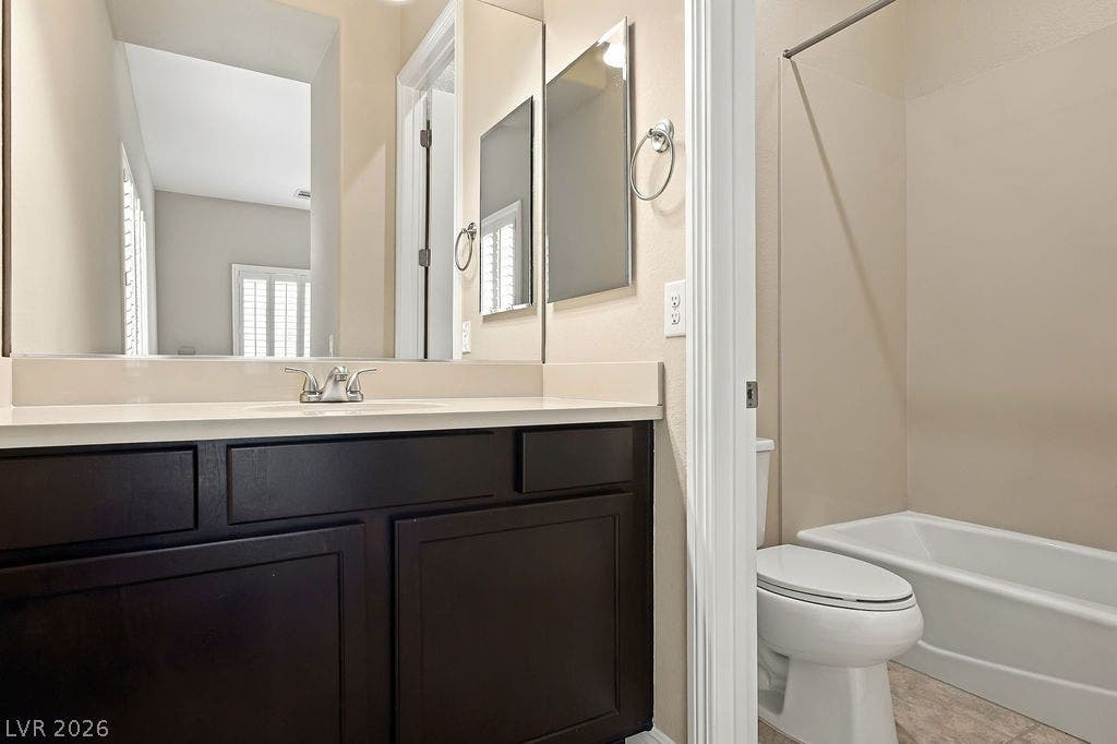 286 Lindura Court, Las Vegas, NV 89138 Dark cabinetry and solid counters anchor this bathroom featuring a separate shower and tub area.