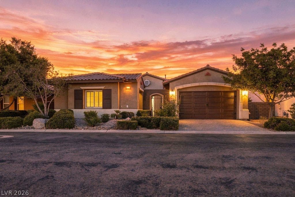 286 Lindura Court, Las Vegas, NV 89138 Warm exterior lights and a paved driveway welcome you to this single-story desert home.