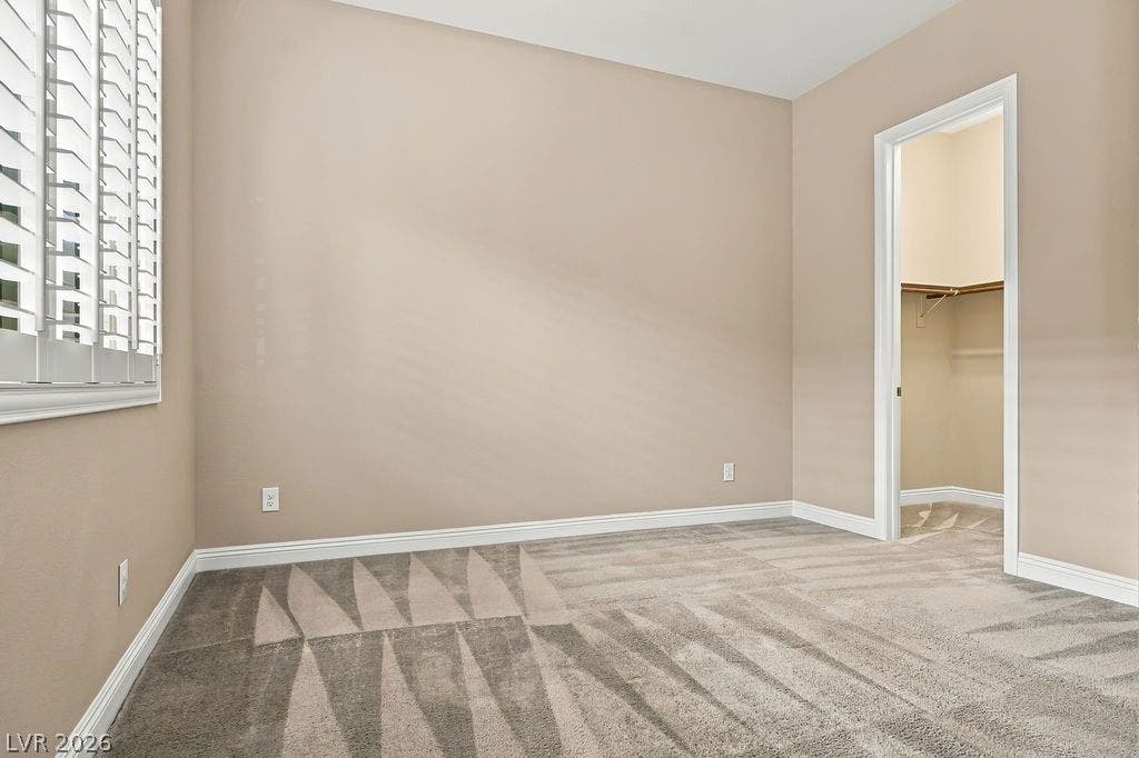 286 Lindura Court, Las Vegas, NV 89138 Plush carpeting and plantation shutters define this versatile bedroom with an attached walk-in closet.