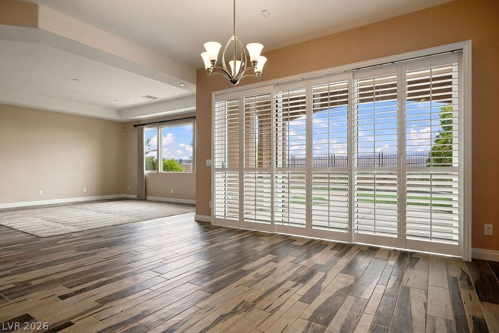 286 Lindura Court, Las Vegas, NV 89138 Plank flooring transitions smoothly into an open living area framed by glass doors.