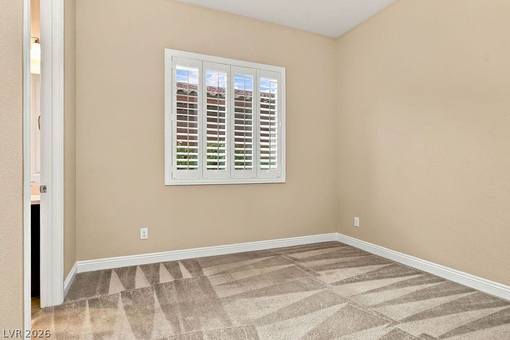 286 Lindura Court, Las Vegas, NV 89138 Plush carpeting and classic plantation shutters define this versatile secondary bedroom space.