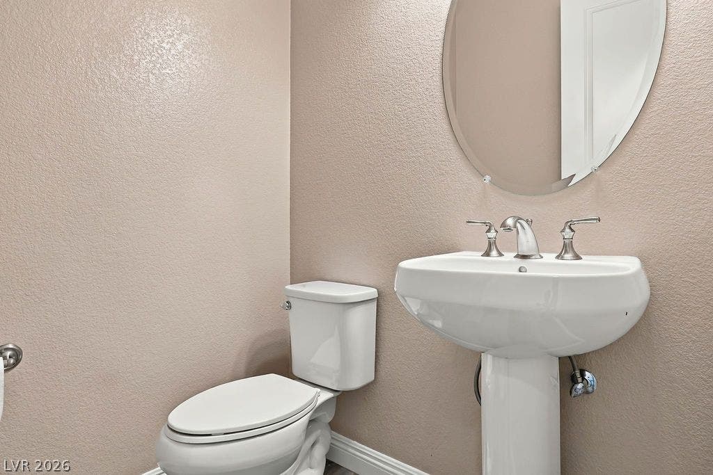 286 Lindura Court, Las Vegas, NV 89138 A classic pedestal sink and oval mirror anchor this neat powder room.