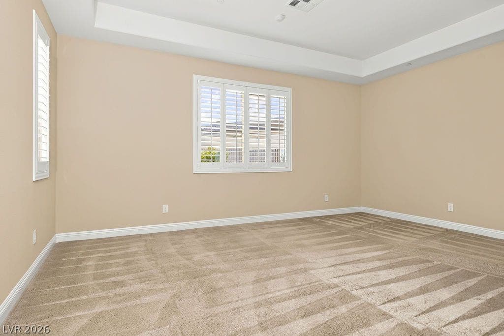 286 Lindura Court, Las Vegas, NV 89138 Plush carpeting anchors this versatile room underneath a tray ceiling with classic plantation shutters.