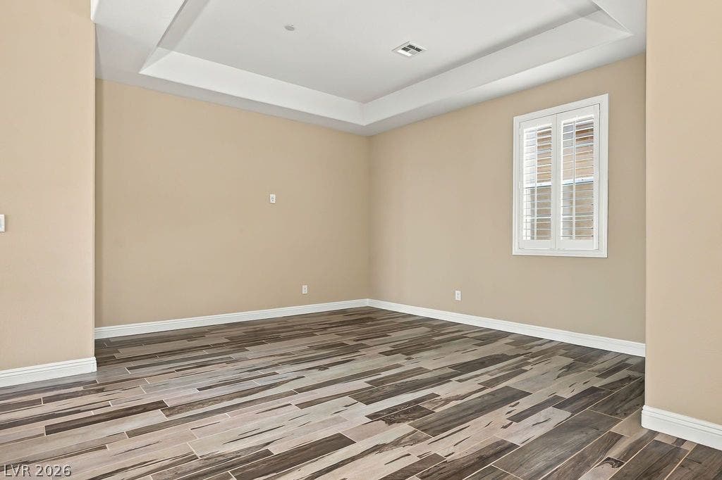 286 Lindura Court, Las Vegas, NV 89138 Recessed ceiling details and patterned plank flooring anchor this versatile interior room.